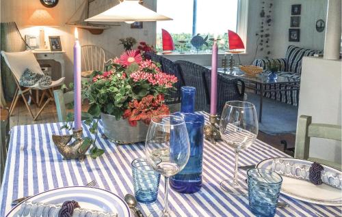 a table with plates and glasses and candles on it at Rosenhavet in Vejby