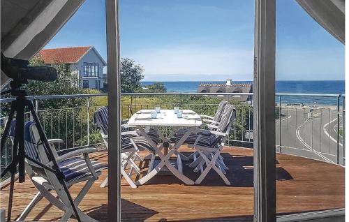 a table and chairs on a balcony with a view of the ocean at Rosenhavet in Vejby