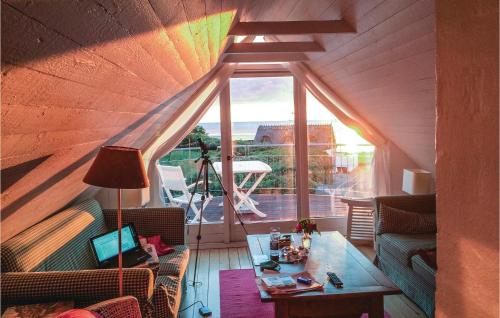 a living room with a table and a large window at Rosenhavet in Vejby