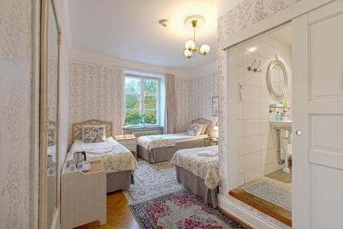 a bedroom with a bed and a dresser at Wasa Park Hotel in Stockholm