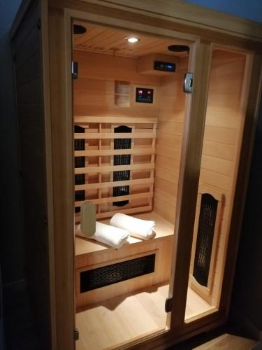 a small sauna with a heater and towels in it at Opera Boutique Rooms in Monreale