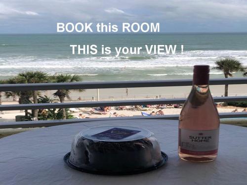 a bottle of wine sitting on a table with a cake at Ocean Walk Resort - Breathtaking Ocean Front View in Daytona Beach
