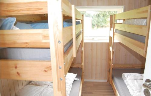 two bunk beds in a room with a window at Cozy Home In Stege With Sauna in Stege