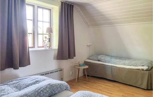 een slaapkamer met 2 bedden en een raam bij Stunning Home In Vaggeryd With 2 Bedrooms And Sauna in Hok