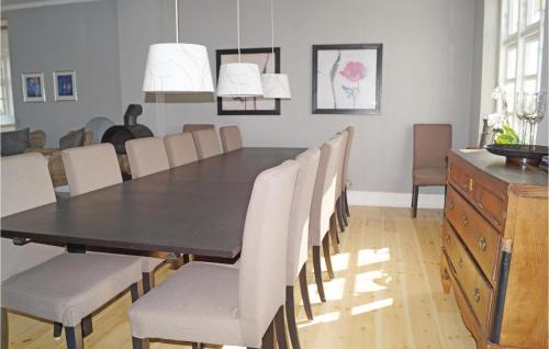 a dining room with a black table and chairs at Holiday Home Stoense Udflyttervej in Skattebølle
