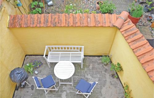 an overhead view of a patio with two chairs and a bench at Holiday Home Assens 7 in Assens
