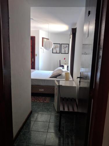 a bedroom with a bed and a sink and a mirror at Hotel Pousada Laje de Itauna in Saquarema