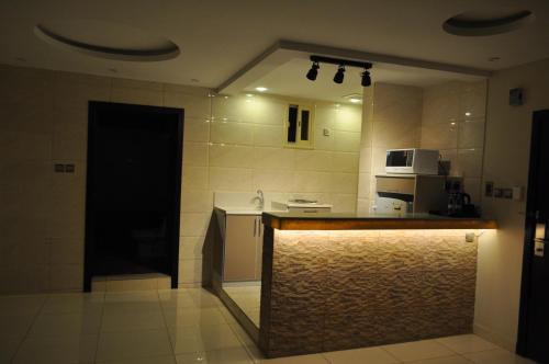 a kitchen with a counter top in a room at شقق منازل الدانة للشقق المخدومة in Abha