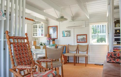 a dining room with a table and chairs at One-Bedroom Holiday Home In Sjolund in Sjølund