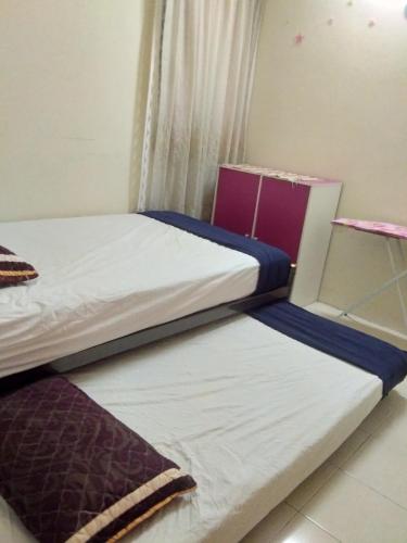 Ένα ή περισσότερα κρεβάτια σε δωμάτιο στο UMMII Homestay
