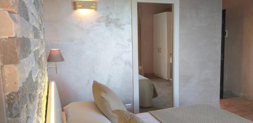 a living room with a couch and a bedroom at Borgo di Santa Barbara in Santa Domenica
