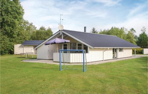 a building with a basketball hoop in the yard at Holiday Home Møllevangen Ix in Ovtrup