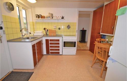a small kitchen with a sink and a stove at Holiday Home Nysted Xcix in Nysted