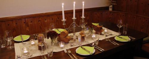 a table with candles and green napkins on it at The Moosbach Garden in Nordrach