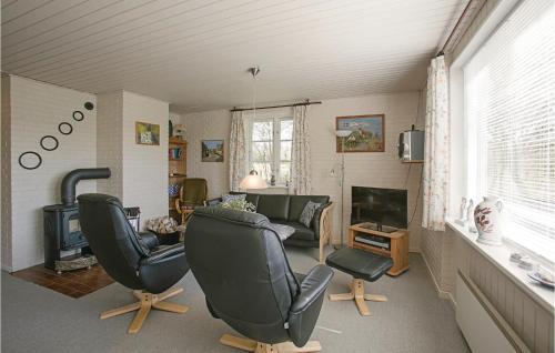 a living room with two chairs and a couch and a television at Bedstes Hus in Vester Sømarken