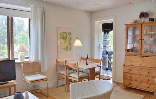 a living room with a table and a dining room at Apartment Kystvej Hornbæk Ii in Hornbæk