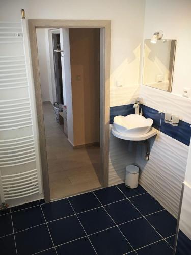 a bathroom with a sink and a mirror at Apartmán 501 in Važec