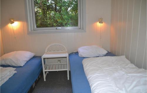 two twin beds in a room with a window at Two-Bedroom Holiday Home In Tarm in Hoven