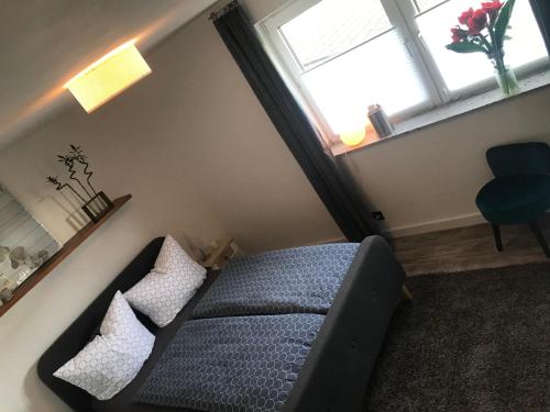 a small room with a bed and a window at Komfort Ferienwohnung à la Bella in Mechernich