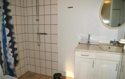 a bathroom with a shower and a sink and a mirror at Two-Bedroom Holiday Home In Tarm in Hoven
