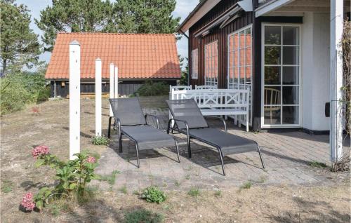 a group of chairs sitting on a patio at Two-Bedroom Holiday Home In Ebeltoft in Ebeltoft