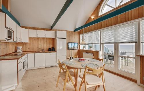 a kitchen with a table and chairs and a dining room at Holiday Home Ny Bamsestræde O-624 in Otterup