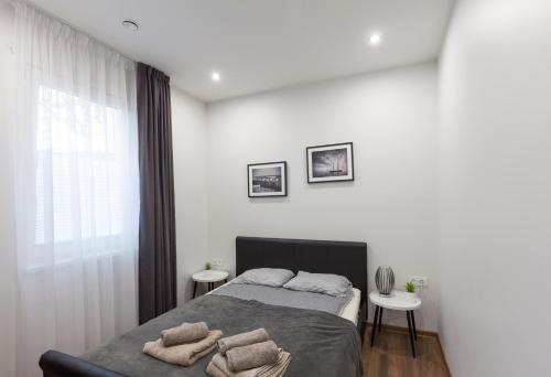 a bedroom with a bed with two pillows on it at Oak house apartments in Kaunas