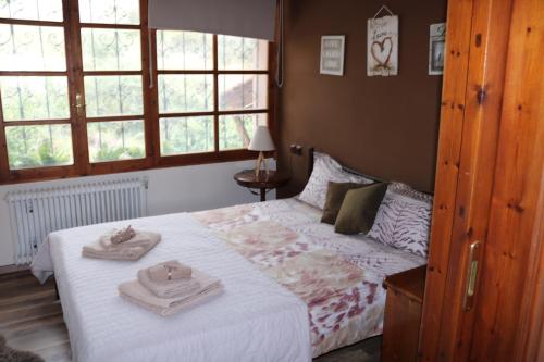 a bedroom with a bed with towels on it at Villa Sofia in Marathos
