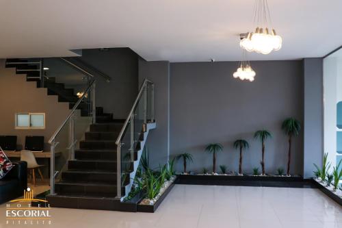 a lobby with stairs and palm trees at HOTEL ESCORIAL PITALITO in Pitalito