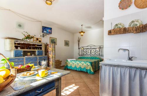 a kitchen with a sink and a room with a bed at Le Navi In Cielo in Imperia