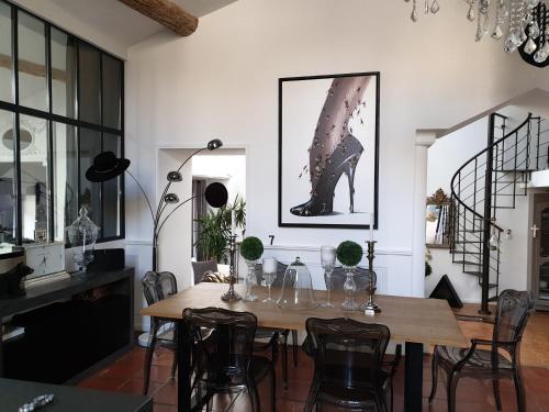 a dining room with a wooden table and chairs at Loft avec spa Lourmarin in Lourmarin