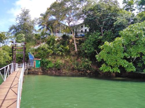 a house on top of a hill next to a river at Boca Brava Lodge in Boca Chica