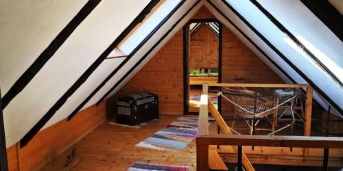 a attic room with a stove and a window at Drevenica pod Tlstou in Blatnica