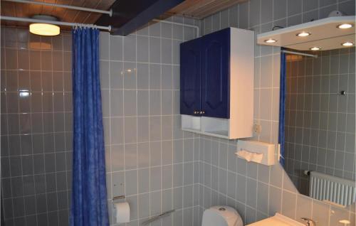 a bathroom with a sink and a blue cabinet at Nice Home In Vggerlse With Wifi in Bøtø By