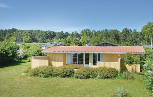 a yellow house with a red roof at Holiday Home Klirevej Kalundborg V in Bjørnstrup