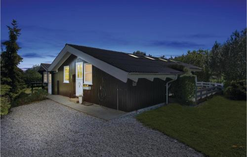 a small house on a gravel driveway at Holiday Home Østparken P-625 in Otterup