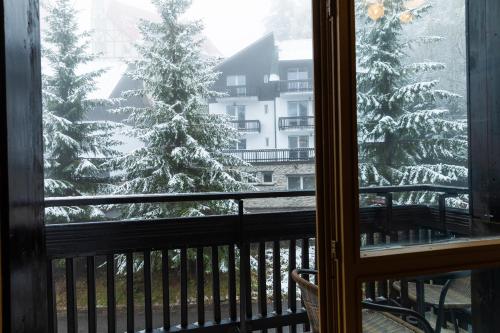 a view of a christmas tree from a balcony at Montana Residence in Poiana Brasov