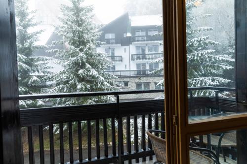 a view of a christmas tree from a balcony at Montana Residence in Poiana Brasov