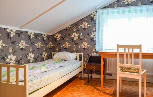 a small bedroom with a bed and a desk at Nice Home In Gamleby With House A Panoramic View in Gamleby