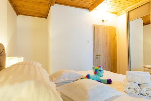 a stuffed animal sitting on top of a bed at Montana Residence in Poiana Brasov
