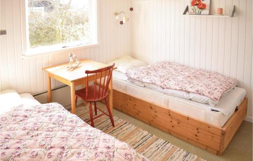a bedroom with two beds and a desk and a chair at Nice Home In Bogense With Wifi in Bogense