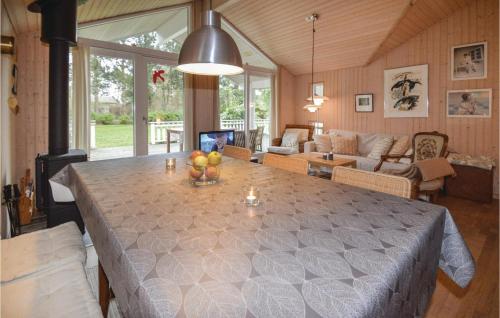 a living room with a large table with fruit on it at Three-Bedroom Holiday Home In Lundby in Lundby