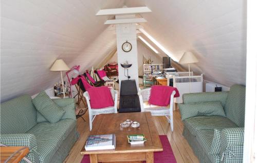 a living room with two green couches and a table at Rosenhavet in Vejby