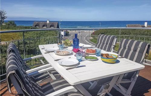 a white table with food on a balcony with the ocean at Rosenhavet in Vejby