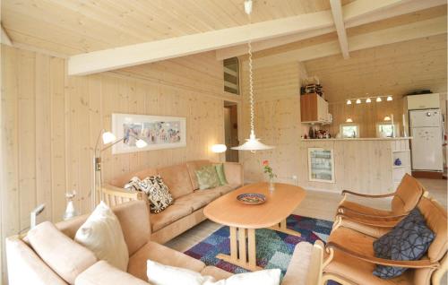 a living room with a couch and a table at Three-Bedroom Holiday Home In Vaggerlose in Marielyst