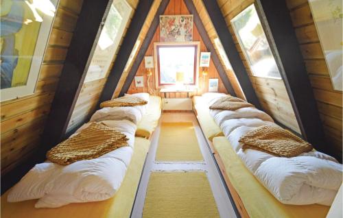 a group of beds in a room in a house at Holiday Home Golfsvinget in Gatten