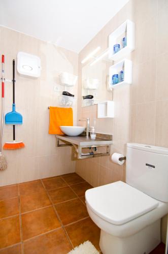 a bathroom with a white toilet and a sink at Casa Piedra Picuda 1 in Mogán