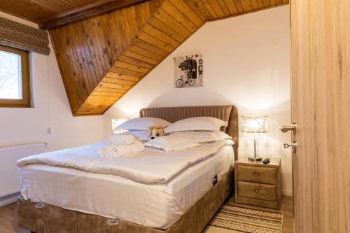 a bedroom with a bed with two stuffed animals on it at Montana Residence in Poiana Brasov