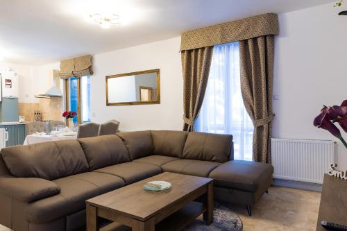 a living room with a couch and a table at Montana Residence in Poiana Brasov