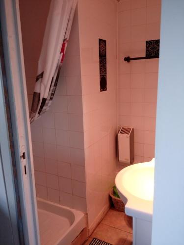 a bathroom with a sink and a tub and a toilet at Domaine du mont scolan in Montgardon